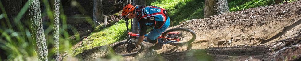 Full suspension mountain bike riding a berm